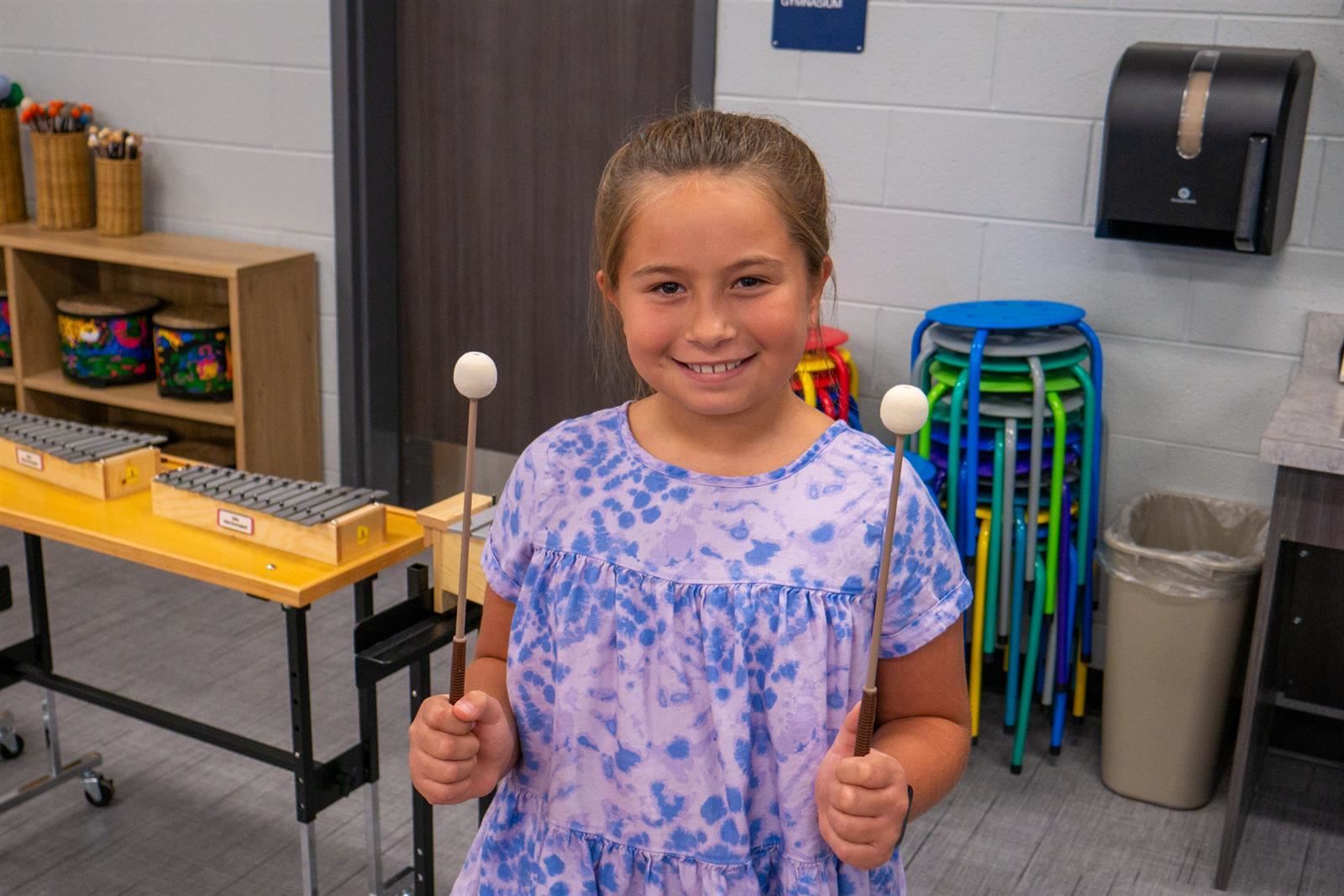 girl holding drumsticks